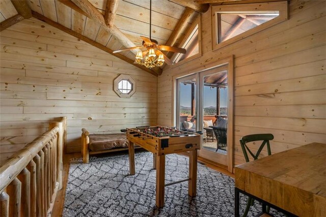 playroom featuring wooden walls and lofted ceiling with beams