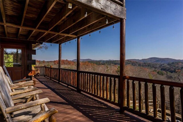 wooden deck with a mountain view