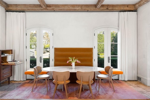 sunroom with beam ceiling, french doors, and plenty of natural light