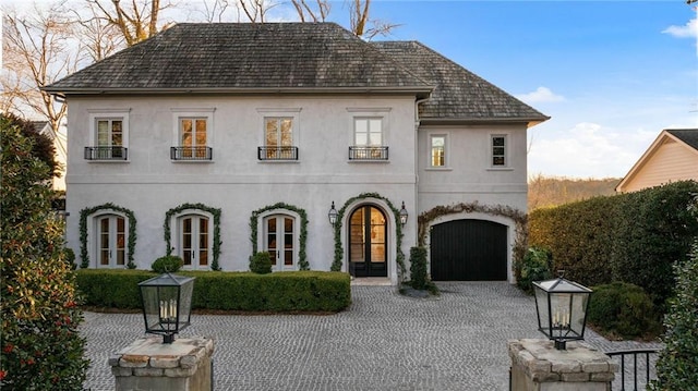 view of front of property with a garage and french doors