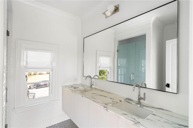 bathroom with vanity, a wealth of natural light, and crown molding