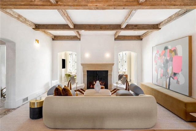 living room featuring beamed ceiling and coffered ceiling