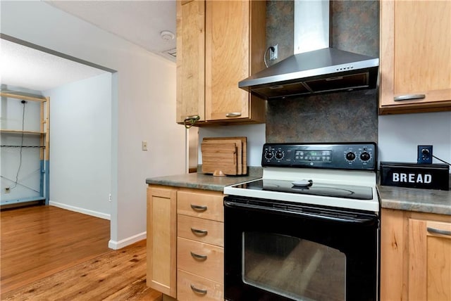 kitchen with electric range, decorative backsplash, light wood-style floors, light brown cabinets, and wall chimney range hood