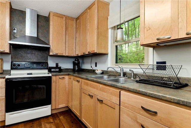 kitchen with electric range, dark countertops, dark wood-style floors, wall chimney range hood, and a sink