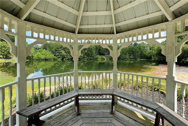 wooden deck featuring a water view and a gazebo