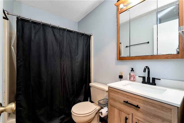 full bath featuring curtained shower, vanity, toilet, and a textured ceiling