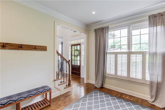 entrance foyer with dark hardwood / wood-style flooring and ornamental molding