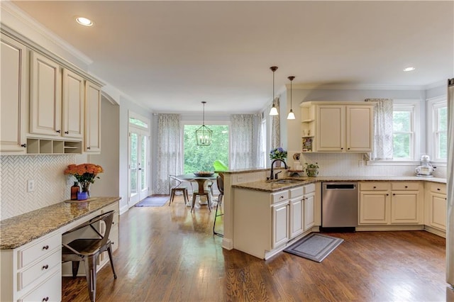 kitchen featuring dark hardwood / wood-style flooring, stainless steel dishwasher, hanging light fixtures, and kitchen peninsula