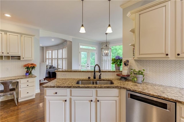 kitchen featuring tasteful backsplash, stainless steel dishwasher, dark hardwood / wood-style floors, sink, and hanging light fixtures