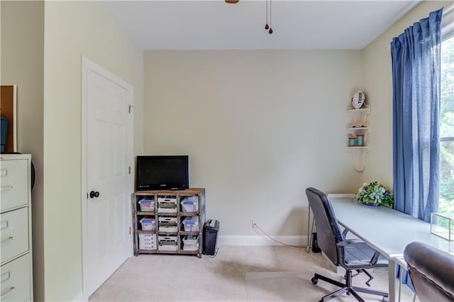 carpeted office space featuring plenty of natural light and ceiling fan