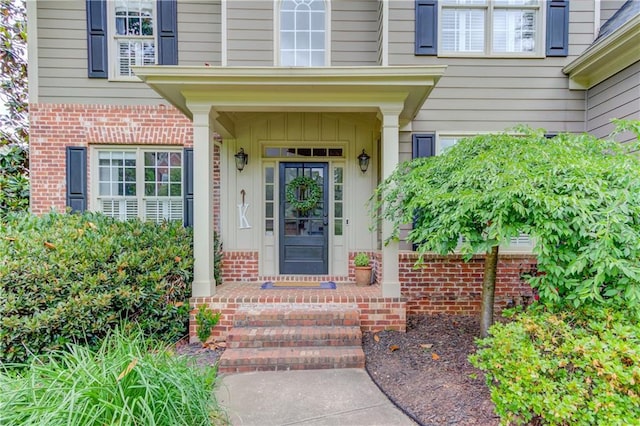 view of exterior entry featuring a porch