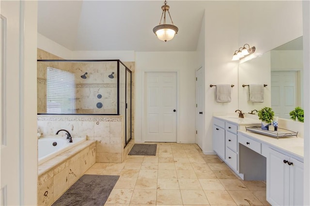 bathroom with independent shower and bath, vaulted ceiling, tile floors, and vanity