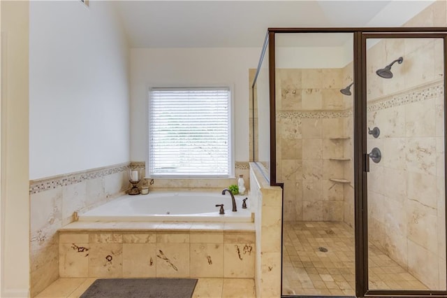 bathroom featuring plus walk in shower and tile floors