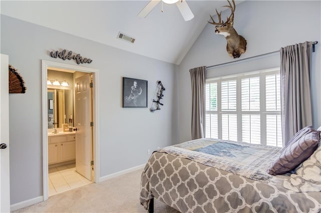 bedroom with ensuite bathroom, lofted ceiling, ceiling fan, sink, and light carpet