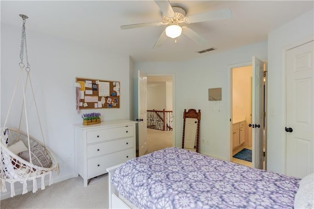 bedroom with light carpet, connected bathroom, and ceiling fan