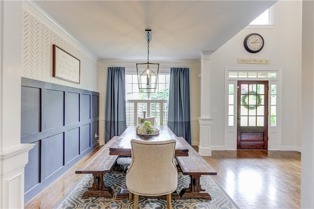 dining room featuring a notable chandelier, crown molding, and hardwood / wood-style flooring