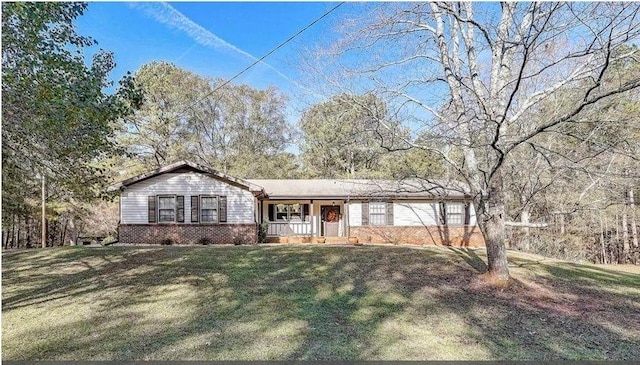 ranch-style home featuring a porch and a front lawn