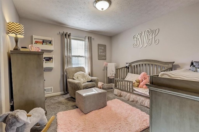 carpeted bedroom featuring a textured ceiling