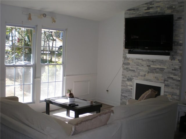 living room featuring a stone fireplace