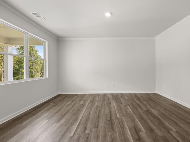 unfurnished room with dark wood finished floors, baseboards, and crown molding