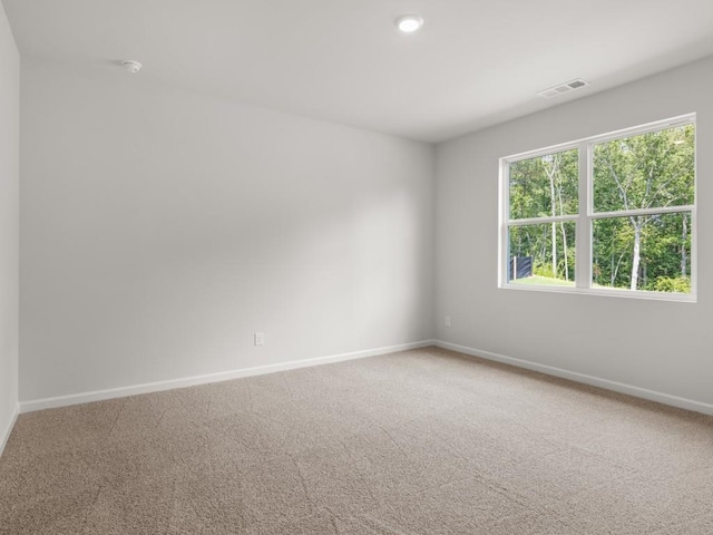 carpeted spare room featuring baseboards and recessed lighting