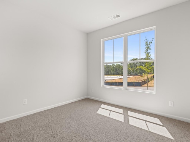 empty room with carpet and baseboards