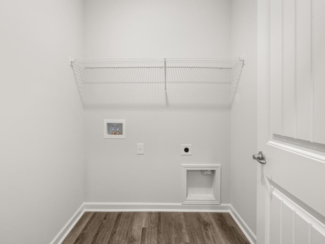 washroom featuring hookup for an electric dryer, hookup for a washing machine, dark wood-style flooring, and baseboards