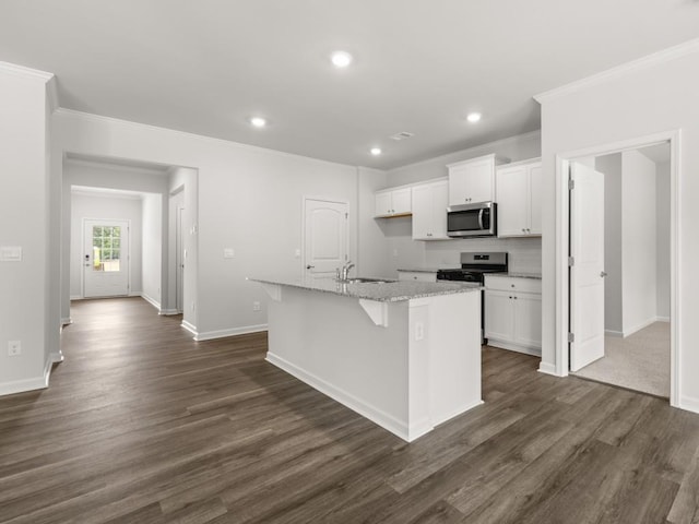 kitchen featuring appliances with stainless steel finishes, a sink, a kitchen island with sink, white cabinetry, and ornamental molding