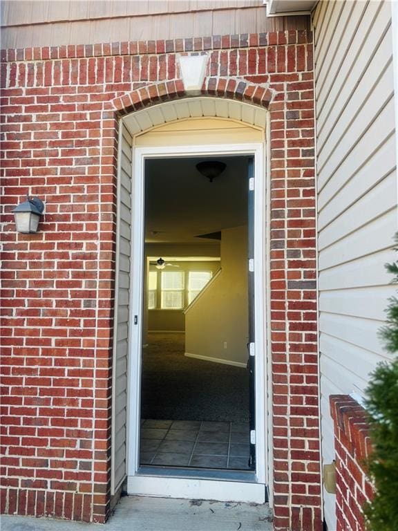 doorway to property featuring brick siding