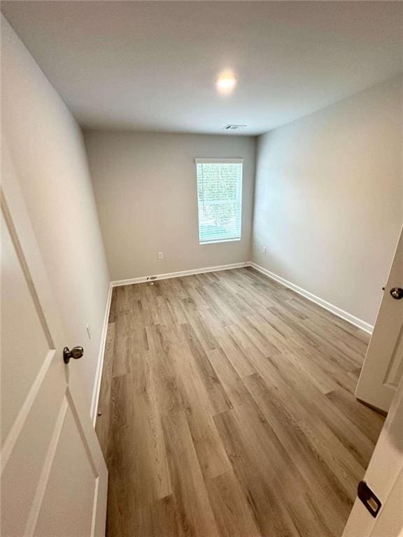 unfurnished room with light hardwood / wood-style flooring