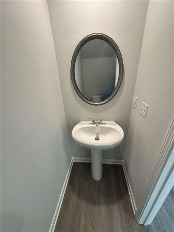 bathroom with hardwood / wood-style flooring and sink