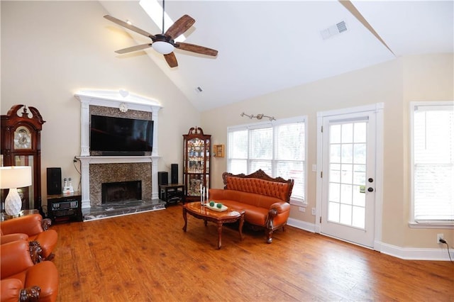 4000 Longlake Dr, Duluth, GA 30097 - living room with a tiled fireplace, wood finished floors, a ceiling fan, high vaulted ceiling, and healthy amount of natural light