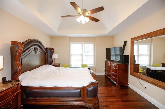 4000 Longlake Dr, Duluth, GA 30097 - bedroom featuring dark wood finished floors, a tray ceiling, vaulted ceiling, baseboards, and ceiling fan