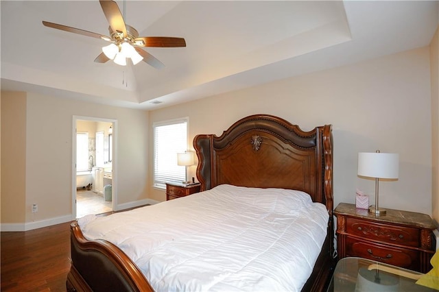 4000 Longlake Dr, Duluth, GA 30097 - bedroom featuring a raised ceiling, wood finished floors, baseboards, a ceiling fan, and ensuite bath