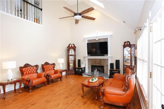 4000 Longlake Dr, Duluth, GA 30097 - living room featuring high vaulted ceiling, a ceiling fan, wood finished floors, healthy amount of natural light, and a tiled fireplace