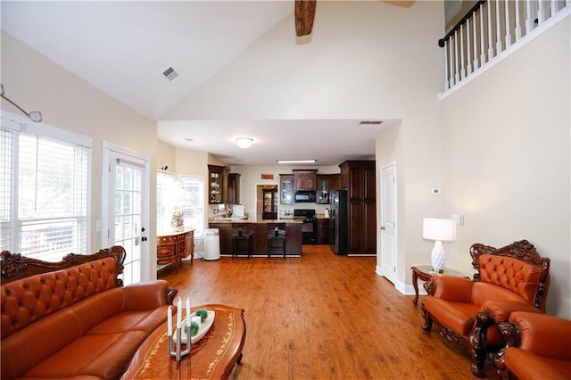 4000 Longlake Dr, Duluth, GA 30097 - living room featuring high vaulted ceiling, light wood-style floors, ceiling fan, baseboards, and beam ceiling