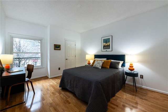 bedroom with light wood-type flooring and baseboards