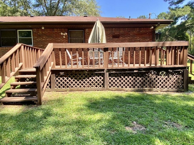 deck with stairs and a yard