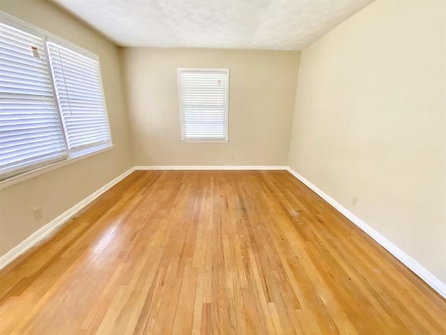 unfurnished room featuring light wood-style floors and baseboards