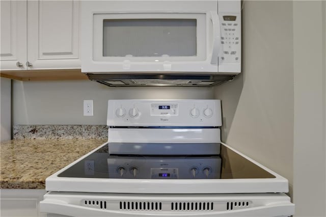 room details with white appliances and white cabinetry