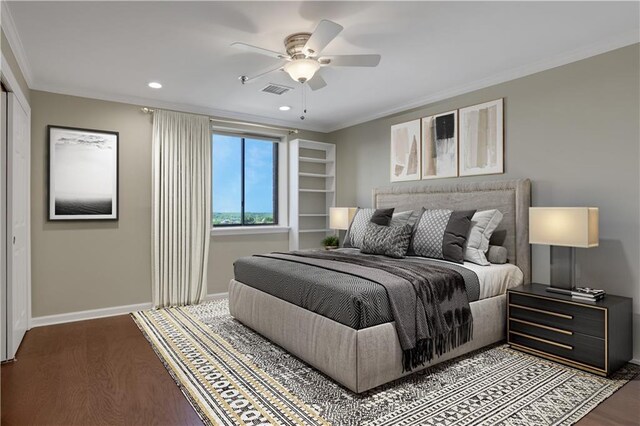 bedroom with ceiling fan, hardwood / wood-style floors, and ornamental molding