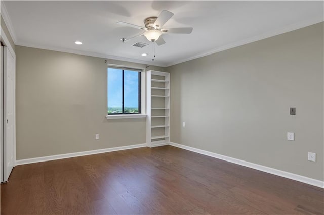 unfurnished room featuring ceiling fan, crown molding, and dark wood-type flooring