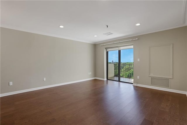 empty room featuring ornamental molding and wood-type flooring