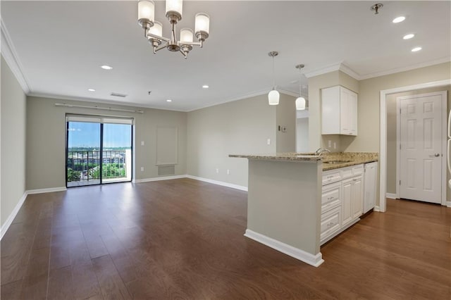 kitchen featuring dark hardwood / wood-style flooring, ornamental molding, white cabinets, light stone countertops, and an inviting chandelier