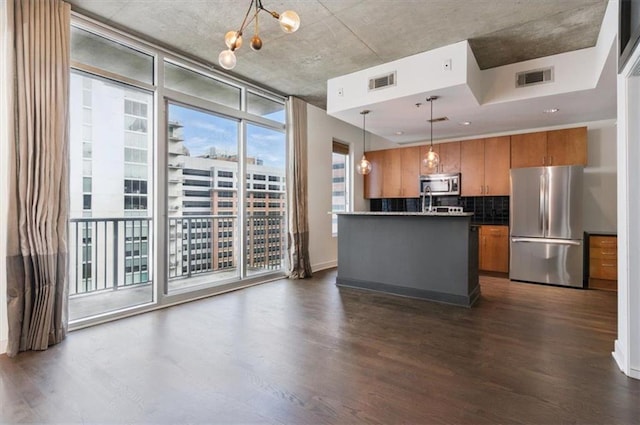 44 Peachtree Pl NW Unit 1728, Atlanta, GA 30309 - kitchen featuring stainless steel appliances, brown cabinets, dark wood-style flooring, and expansive windows