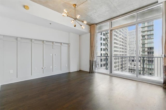 44 Peachtree Pl NW Unit 1728, Atlanta, GA 30309 - spare room featuring wood finished floors, a chandelier, and a smoke detector