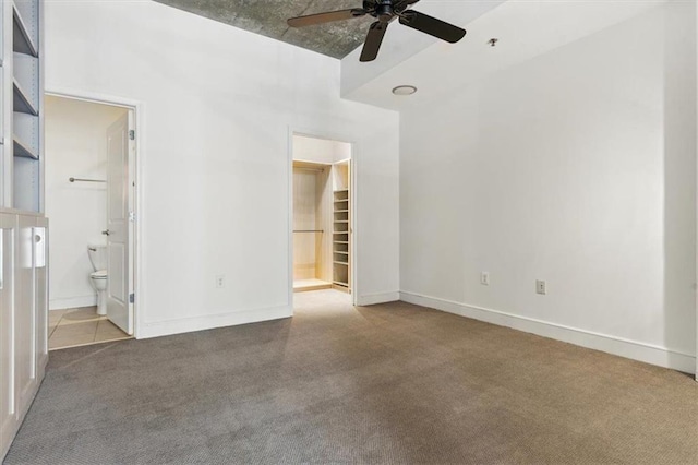 44 Peachtree Pl NW Unit 1728, Atlanta, GA 30309 - unfurnished bedroom featuring carpet flooring, a spacious closet, ensuite bathroom, and baseboards