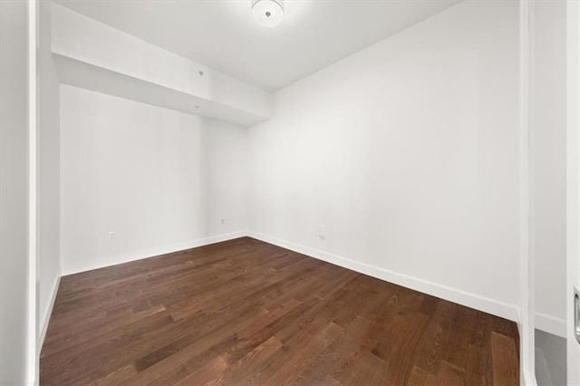 spare room featuring dark hardwood / wood-style flooring