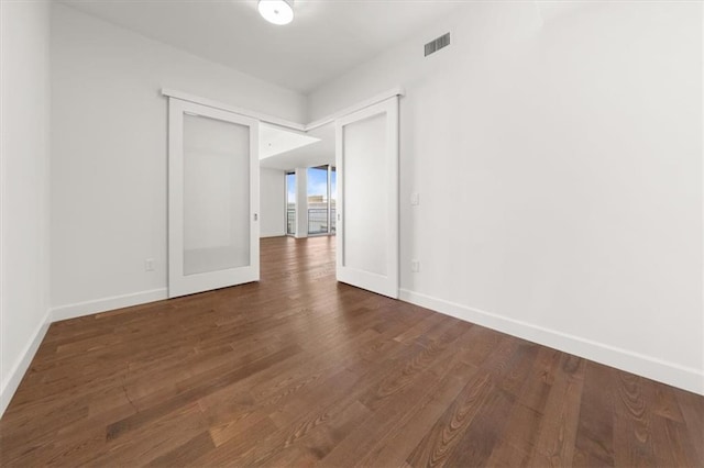 empty room featuring dark wood-type flooring