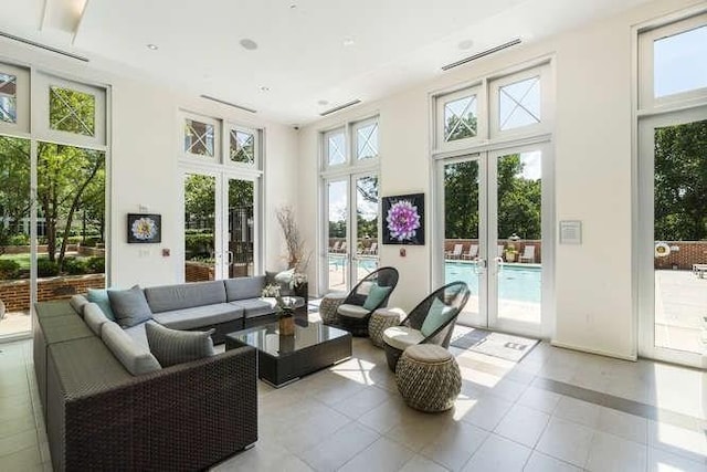 sunroom / solarium featuring french doors